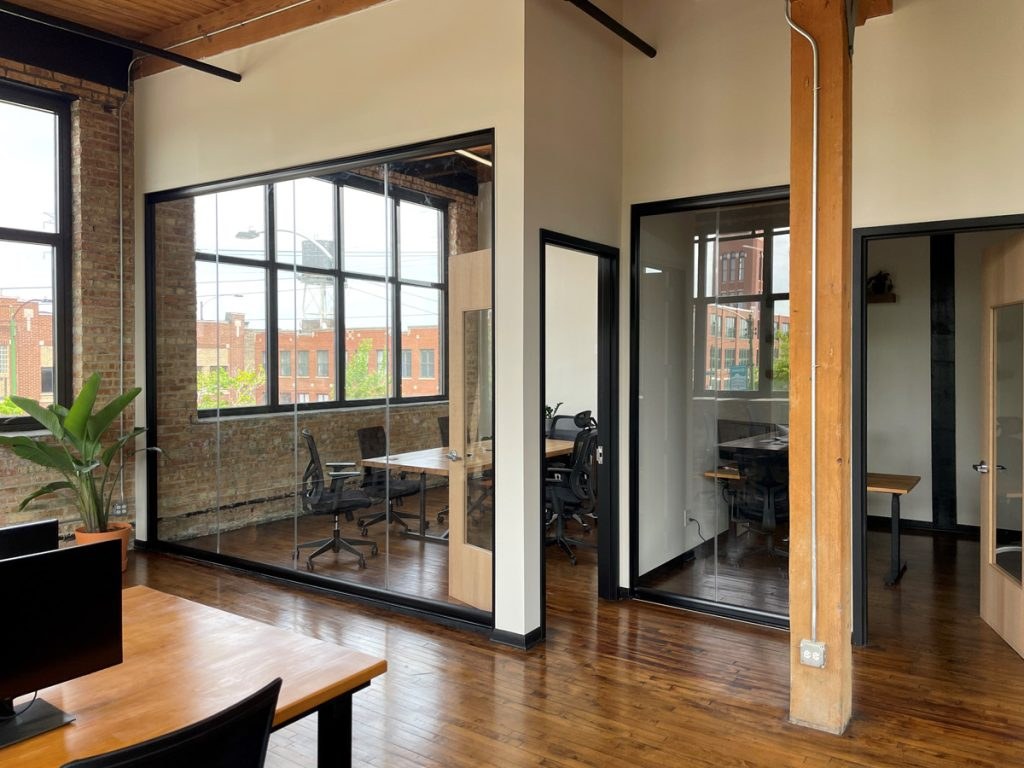 NXT Wall View Series frameless offices in an industrial loft building